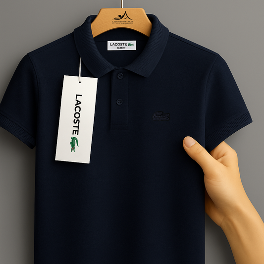 Navy blue Lacoste polo shirt on a hanger with a visible tag against a gray background